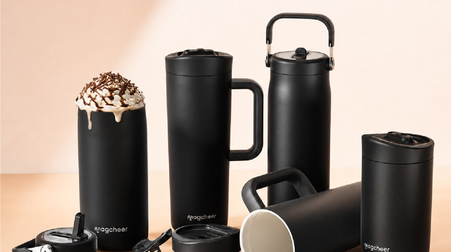 A collection of black Magcheer tumblers, mugs, and bottles